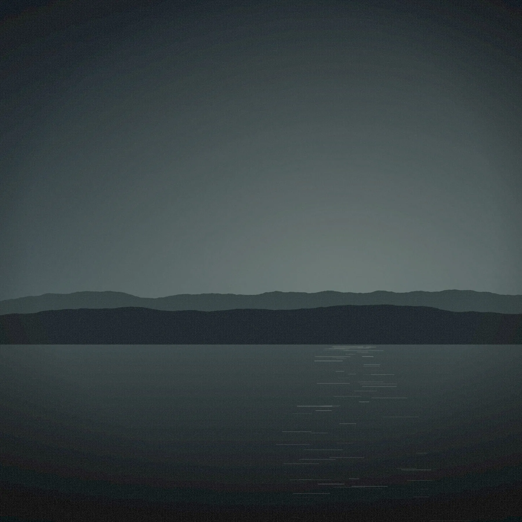 A misty reservoir with low hills on the far shore under a flat grey sky.